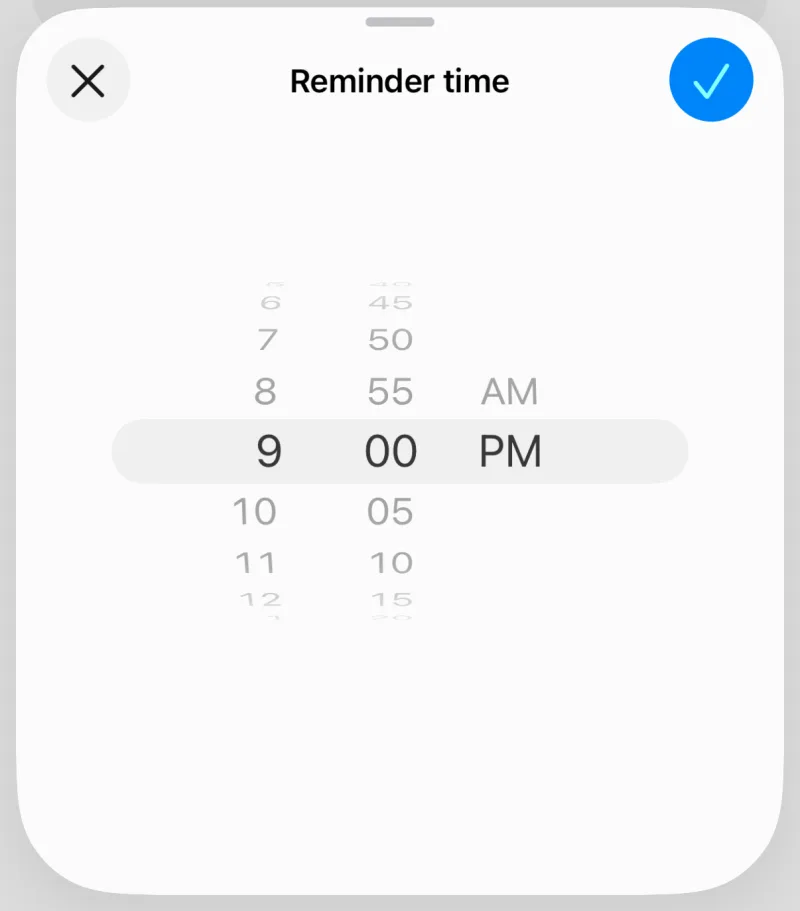 Hook's reminder time sheet with a time wheel set to 9:00 PM, a close button and a checkmark to save